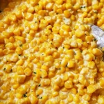 Delicious bowl of homemade creamed corn topped with herbs