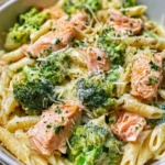 Creamy salmon broccoli pasta dish with herbs and spices