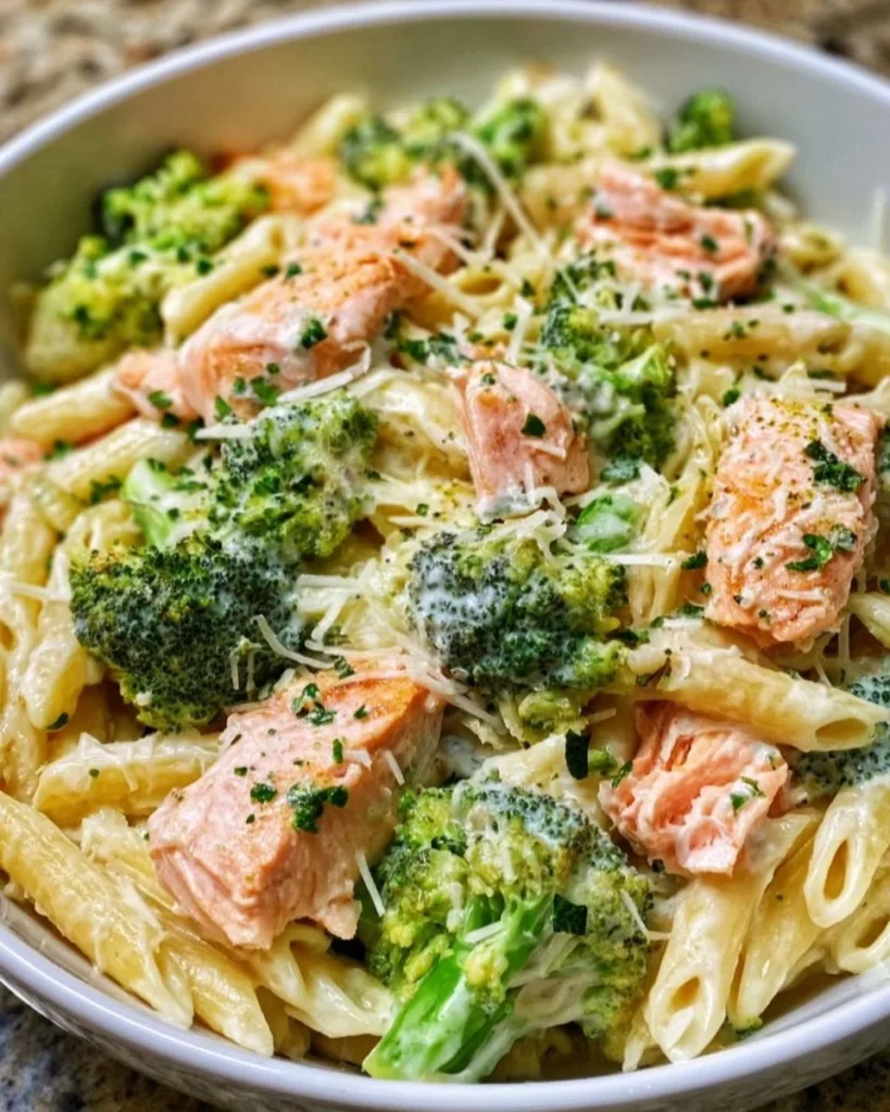 Creamy salmon broccoli pasta dish with herbs and spices