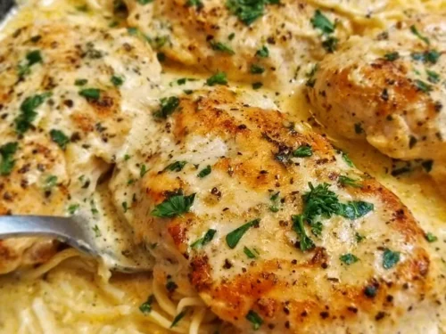 Crock Pot Angel Chicken recipe served in a bowl with herbs and side dishes