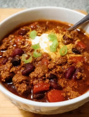 Delicious Crock Pot Chili served in a bowl garnished with herbs