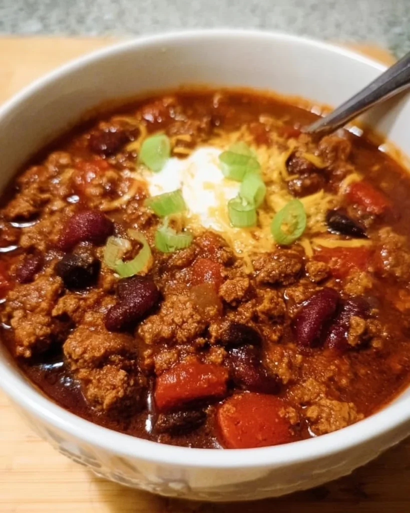 Delicious Crock Pot Chili served in a bowl garnished with herbs
