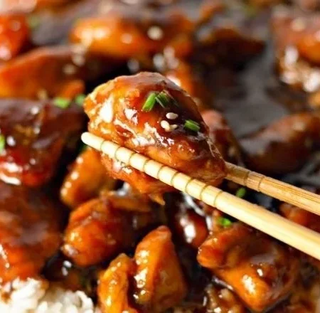 Plate of delicious Bourbon Chicken served with rice and vegetables