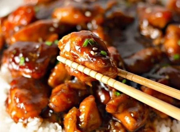 Plate of delicious Bourbon Chicken served with rice and vegetables