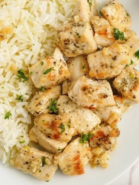 Plate of easy garlic butter chicken bites garnished with herbs
