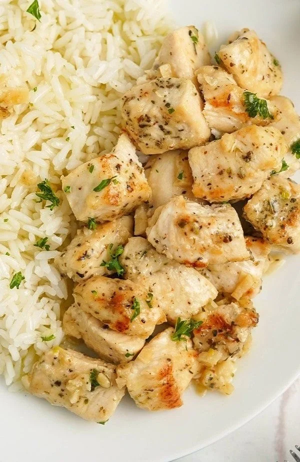 Plate of easy garlic butter chicken bites garnished with herbs