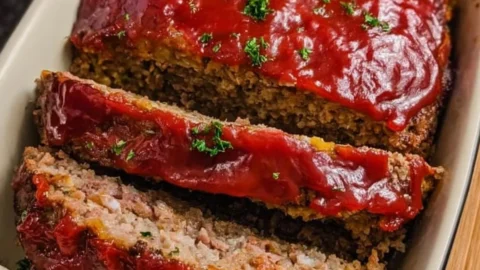 Delicious slice of Mom's Best Meatloaf served with mashed potatoes and green beans