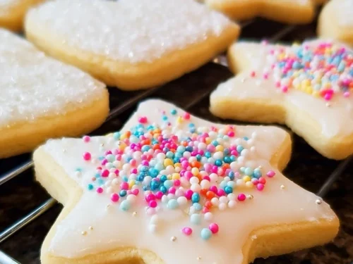 Soft cut-out sugar cookies decorated with icing and sprinkles.