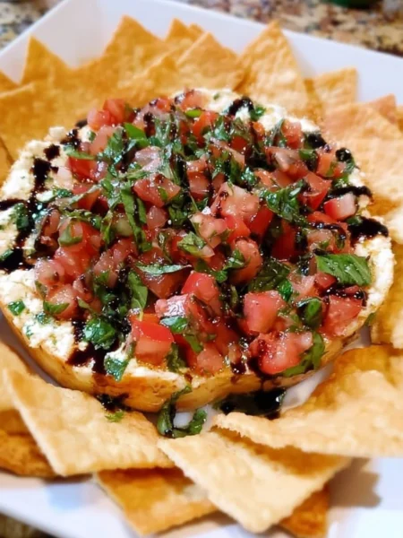 Delicious bruschetta dip served in a bowl with fresh toppings