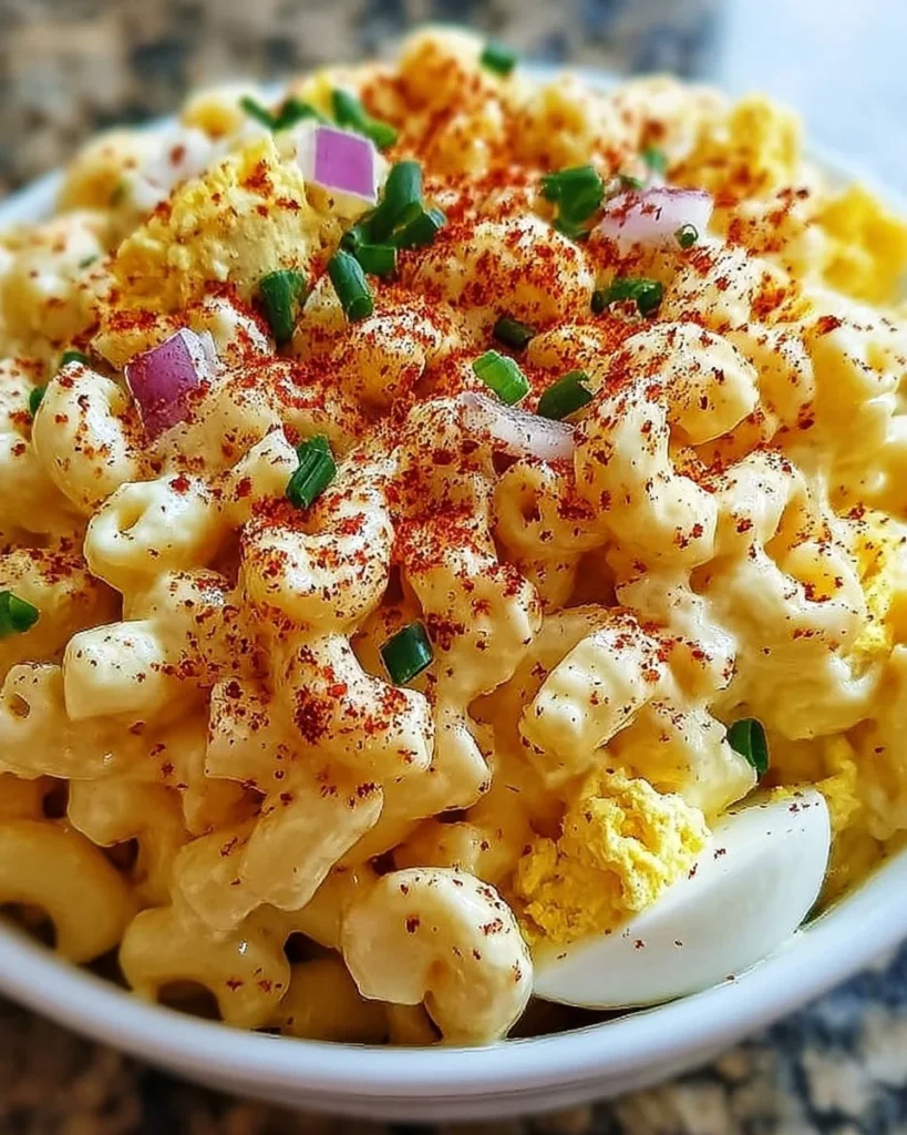 Creamy deviled egg macaroni salad served in a bowl