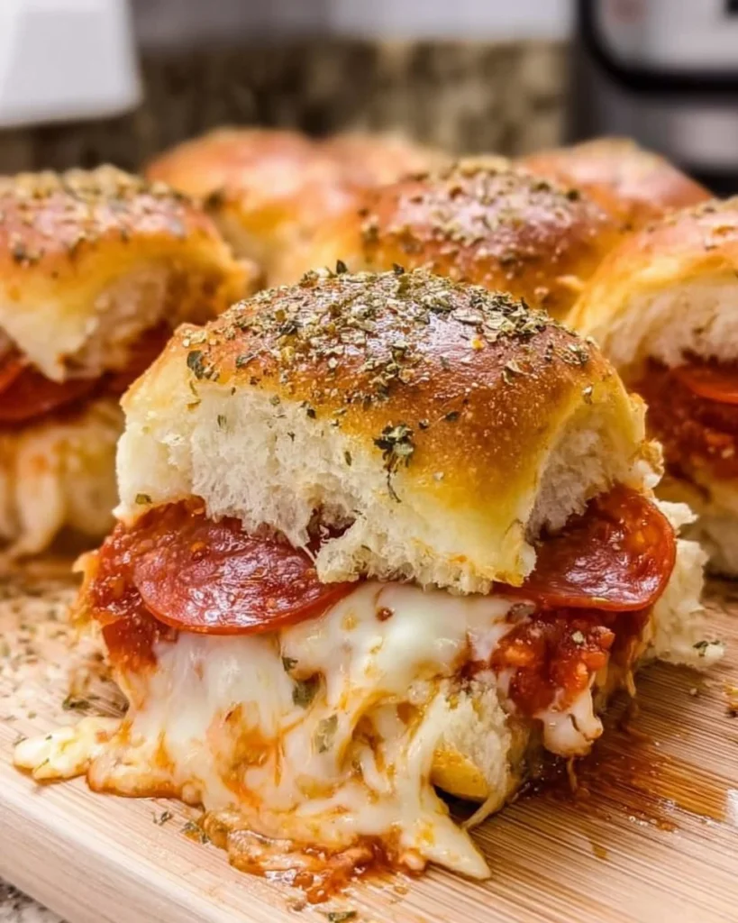 Delicious homemade pizza sliders served on a platter with toppings.