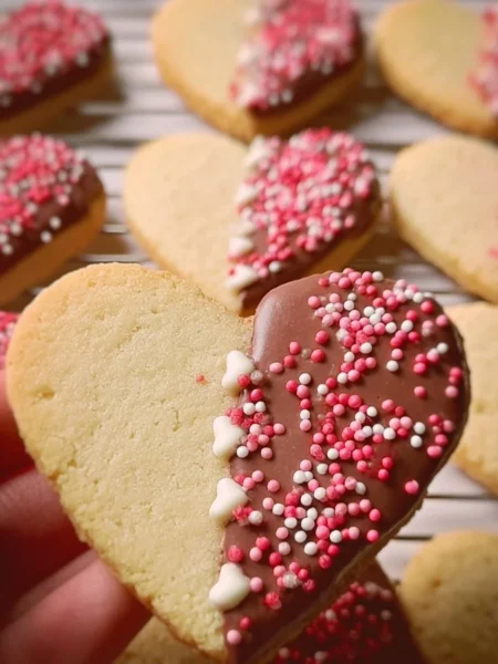 Delicious Valentine's Shortbread Hearts decorated with icing and sprinkles.