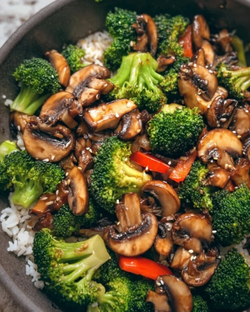 Vegan broccoli and mushroom stir fry served in a bowl with fresh vegetables