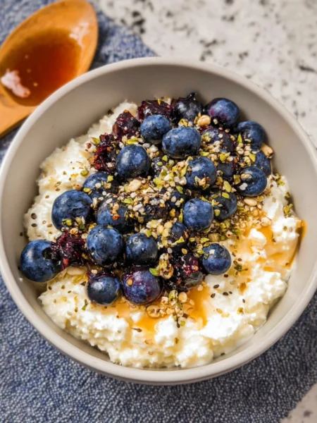 Healthy blueberry cottage cheese bowl topped with fresh blueberries and nuts.
