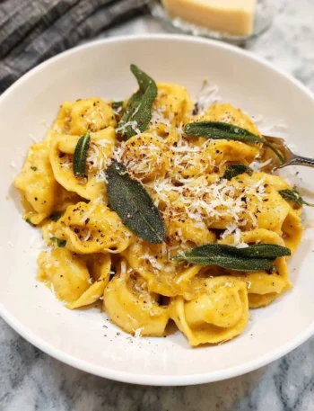 Creamy brown butter and sage pumpkin pasta garnished with fresh herbs