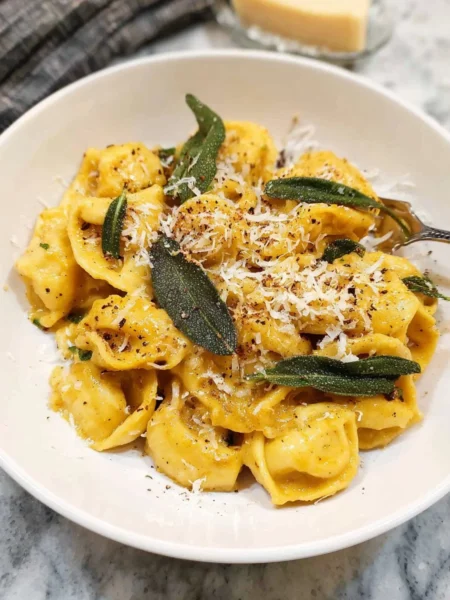 Creamy brown butter and sage pumpkin pasta garnished with fresh herbs