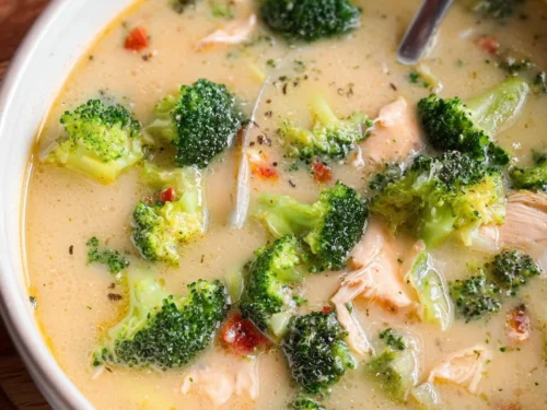 Bowl of delicious Chicken Broccoli Soup garnished with fresh herbs