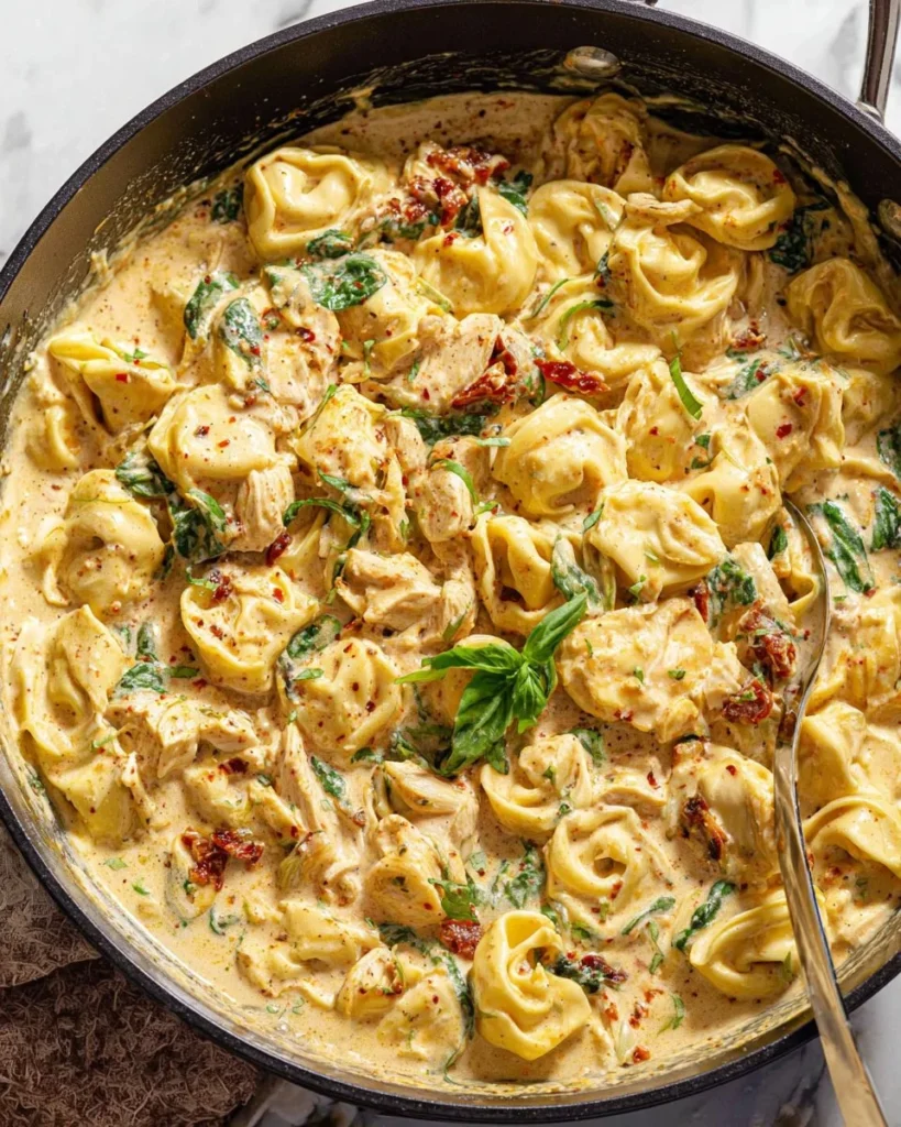 Creamy Tuscan Chicken Tortellini served in a bowl with fresh herbs
