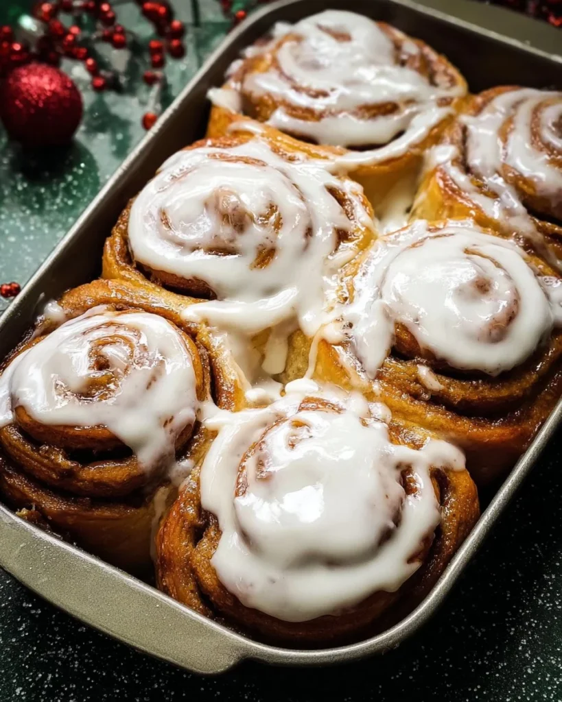 Frosted Gingerbread Cinnamon Rolls topped with creamy icing