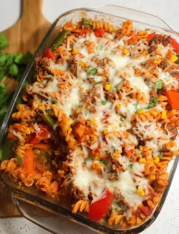 Delicious stuffed pepper pasta bake in a dish, topped with cheese and herbs.